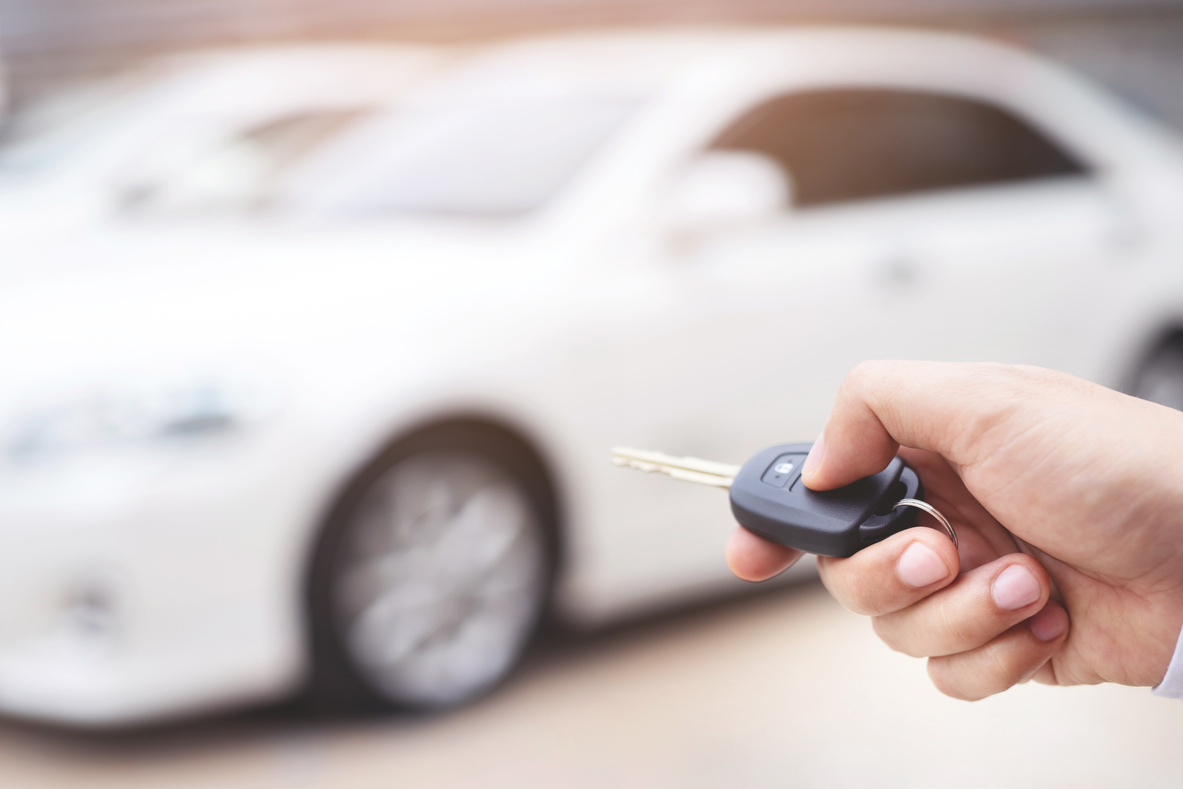 Car Dealer Giving Car Key to New Owner