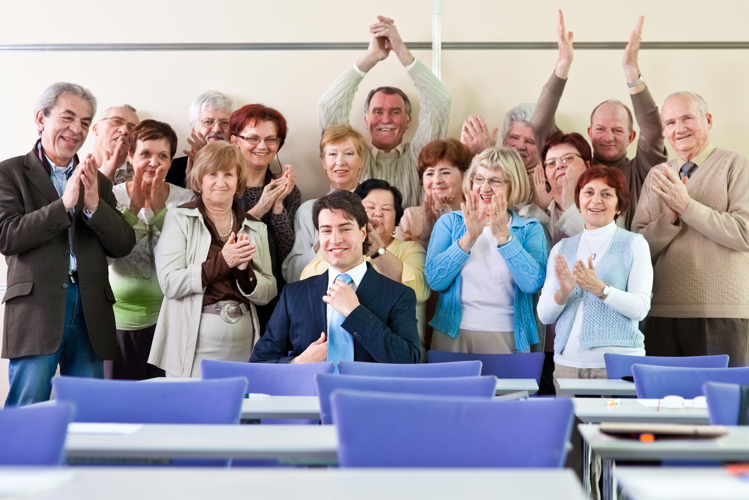 Seniors in the community center applauding